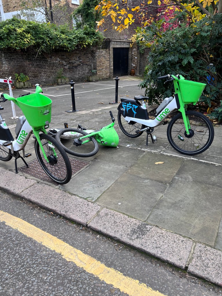 Electric Lime bicycles blocking an urban pavement